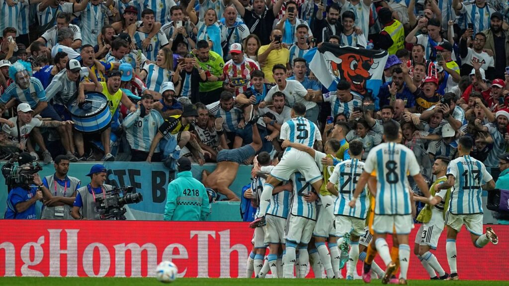 Argentina's fans cheers as Argentina's players celebrates after scoring their side's second goal during the World Cup quarterfinal soccer match between the Netherlands and Argentina, at the Lusail Stadium in Lusail, Qatar, Friday, Dec. 9, 2022. (AP Photo/Jorge Saenz)